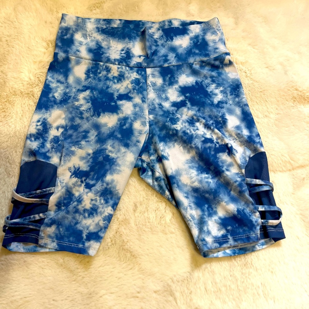 Blue and white biker shorts with mesh pattern on bottom half side